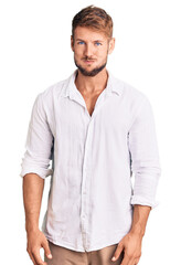 Obraz premium Young caucasian man wearing casual clothes puffing cheeks with funny face. mouth inflated with air, crazy expression.