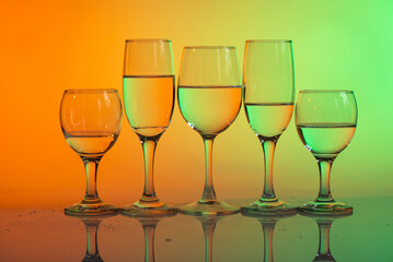 Wine glasses with neon multicolor light