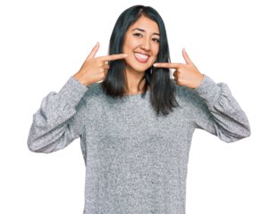 Beautiful asian young woman wearing casual clothes smiling cheerful showing and pointing with fingers teeth and mouth. dental health concept.