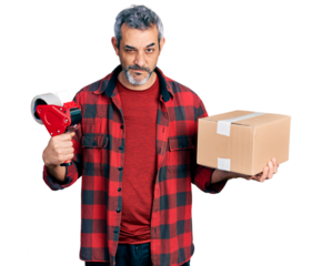Middle age hispanic with grey hair holding packing tape and cardboard box skeptic and nervous, frowning upset because of problem. negative person.