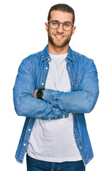 Young caucasian man wearing casual clothes happy face smiling with crossed arms looking at the...