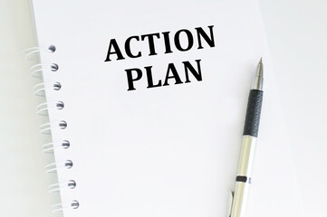 Action plan inscription on a notebook on a table next to a pen, a business concept