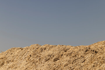 A huge pile of sawdust at a woodworking company