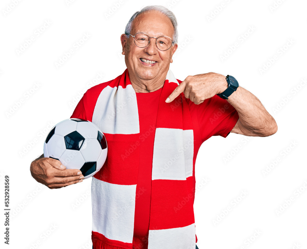 Poster Senior man with grey hair football hooligan holding ball looking confident with smile on face, pointing oneself with fingers proud and happy.