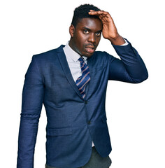 Handsome business black man wearing business suit and tie surprised with hand on head for mistake, remember error. forgot, bad memory concept.