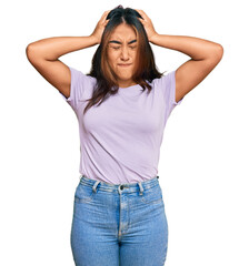 Young latin woman wearing casual clothes suffering from headache desperate and stressed because pain and migraine. hands on head.