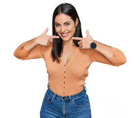 Young hispanic woman wearing casual clothes smiling cheerful showing and pointing with fingers...