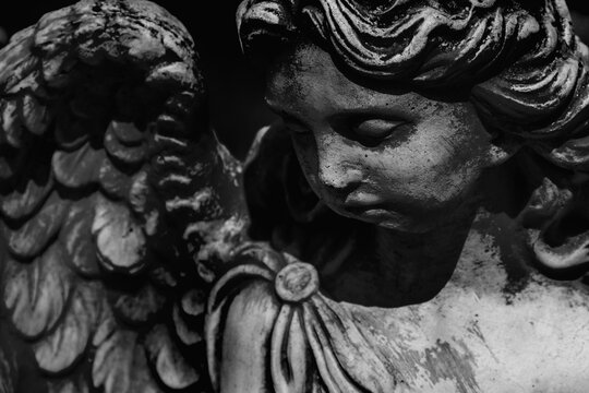 Death. Sad beautiful angel as symbol of pain, fear and end of life. Black and white image.