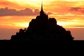 Romantic Red sunset and silhouette of the island of Mont Saint Michel in the North of France