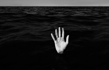 hand on the sea  of a person who is drowning with balck and white effect