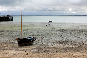 beached boats on the seabed during low tide in the Cancale village in France