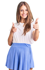 Young beautiful blonde woman wearing summer style pointing fingers to camera with happy and funny face. good energy and vibes.