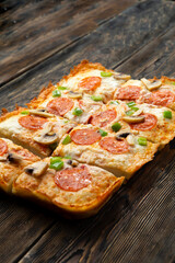 detroit pizza on a wooden table.