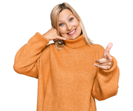 Middle age caucasian woman wearing casual winter sweater smiling doing talking on the telephone gesture and pointing to you. call me.