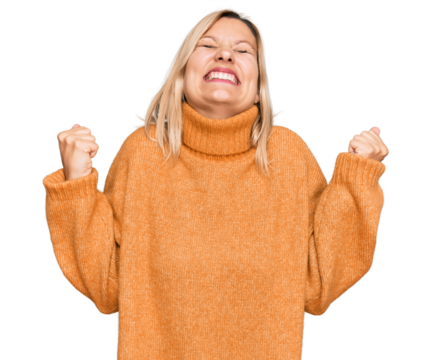 Middle age caucasian woman wearing casual winter sweater very happy and excited doing winner gesture with arms raised, smiling and screaming for success. celebration concept. - Powered by Adobe