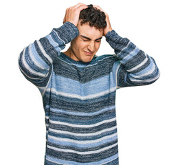 Hispanic young man wearing casual clothes suffering from headache desperate and stressed because pain and migraine. hands on head.