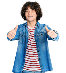 Caucasian teenager wearing casual clothes approving doing positive gesture with hand, thumbs up...