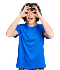 Caucasian teenager wearing casual clothes doing ok gesture like binoculars sticking tongue out, eyes looking through fingers. crazy expression.