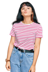 Obraz premium Young hispanic girl wearing casual clothes looking at the camera blowing a kiss on air being lovely and sexy. love expression.