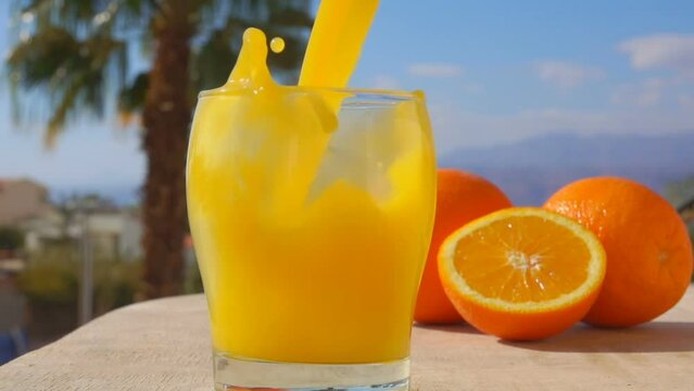 orange juice pouring into a glass