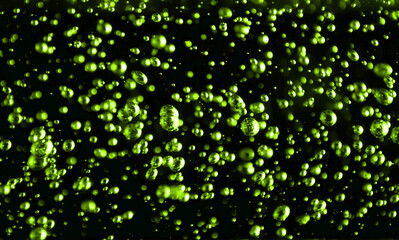 Bubbles close-up on a black background. Oxygen cocktail. Carbonated drink with lots of bright...