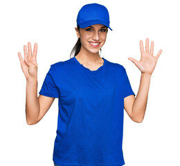 Young hispanic girl wearing delivery courier uniform showing and pointing up with fingers number nine while smiling confident and happy.