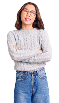 Young beautiful chinese girl wearing casual clothes happy face smiling with crossed arms looking at the camera. positive person.