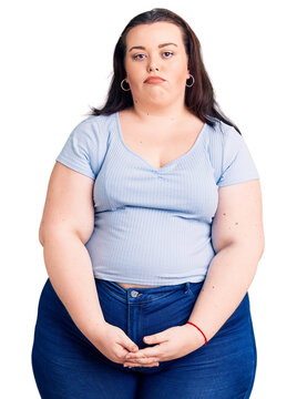Young plus size woman wearing casual clothes depressed and worry for distress, crying angry and afraid. sad expression.