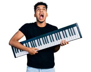 Young african american man holding piano keyboard angry and mad screaming frustrated and furious, shouting with anger looking up.