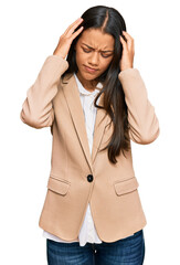 Beautiful hispanic woman wearing business jacket suffering from headache desperate and stressed because pain and migraine. hands on head.