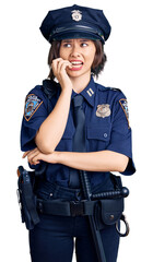 Young beautiful girl wearing police uniform looking stressed and nervous with hands on mouth biting nails. anxiety problem.