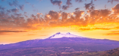 picturesque sunset or sunrise landscape with amazing view to majectic high mountain with snow on top and scenic cloudy sunset on background