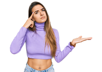 Young hispanic woman wearing casual clothes confused and annoyed with open palm showing copy space and pointing finger to forehead. think about it.