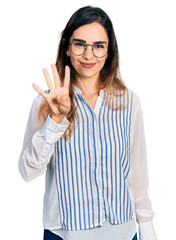 Beautiful hispanic woman wearing casual striped shirt showing and pointing up with fingers number four while smiling confident and happy.