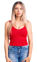 Fototapeta premium Young beautiful blonde woman wearing casual clothes with serious expression on face. simple and natural looking at the camera.