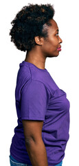 African american woman with afro hair wearing casual purple t shirt looking to side, relax profile pose with natural face and confident smile.