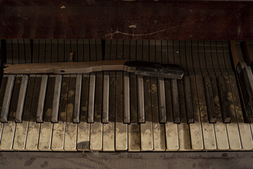 Close up urbex background of wood classical acoustic grand piano keyboard with sepia toned white...