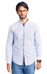 Fototapeta premium Handsome hispanic man wearing business shirt and glasses skeptic and nervous, frowning upset because of problem. negative person.