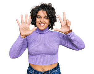 Young hispanic woman with curly hair wearing casual clothes showing and pointing up with fingers number eight while smiling confident and happy.