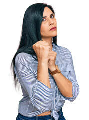 Young caucasian woman wearing casual clothes ready to fight with fist defense gesture, angry and upset face, afraid of problem