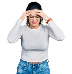 Young hispanic woman wearing casual clothes with hand on head for pain in head because stress....