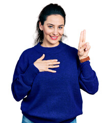 Young hispanic woman wearing casual clothes smiling swearing with hand on chest and fingers up,...