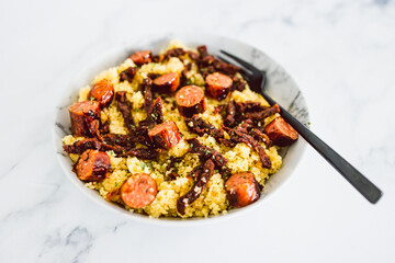 healthy plant-based food, vegan Moroccan inspired couscous with sundried tomatoes and vegan sausage