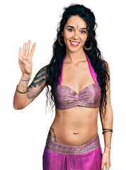 Young indian woman wearing belly dancer costume showing and pointing up with fingers number four while smiling confident and happy.