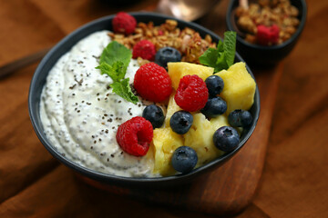 Healthy breakfast bowl with chia yogurt, crunches and fruits.