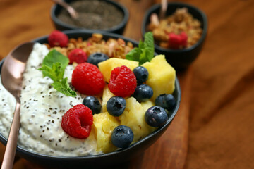 Healthy breakfast bowl with chia yogurt, crunches and fruits.