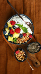 Healthy breakfast bowl with chia yogurt, crunches and fruits.