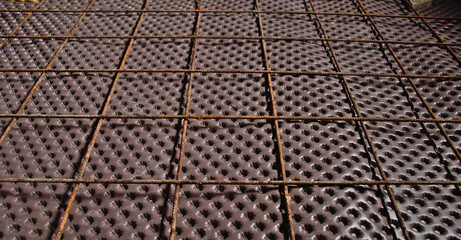 Installation of a geotextile egg cup on the ground to protect from humidity. Iron mesh to cast a concrete slab.