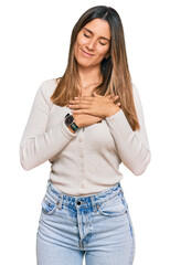 Young woman wearing casual clothes smiling with hands on chest with closed eyes and grateful gesture on face. health concept.