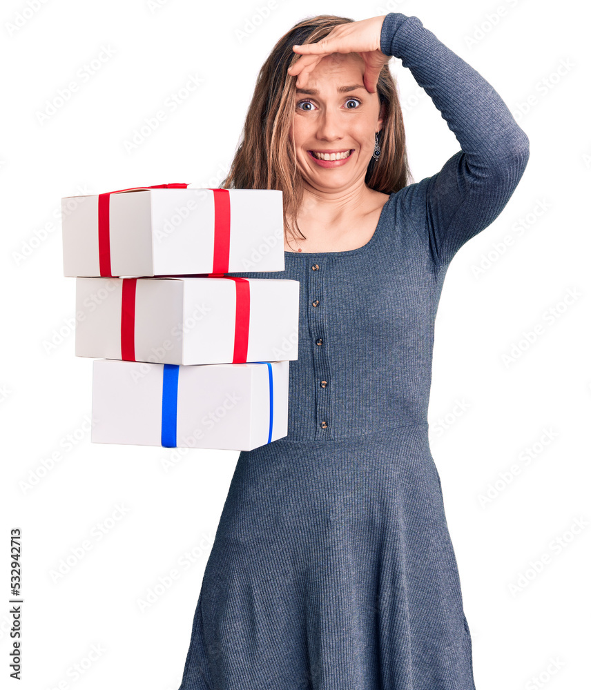 Sticker young beautiful blonde woman holding birthday gift stressed and frustrated with hand on head, surpri